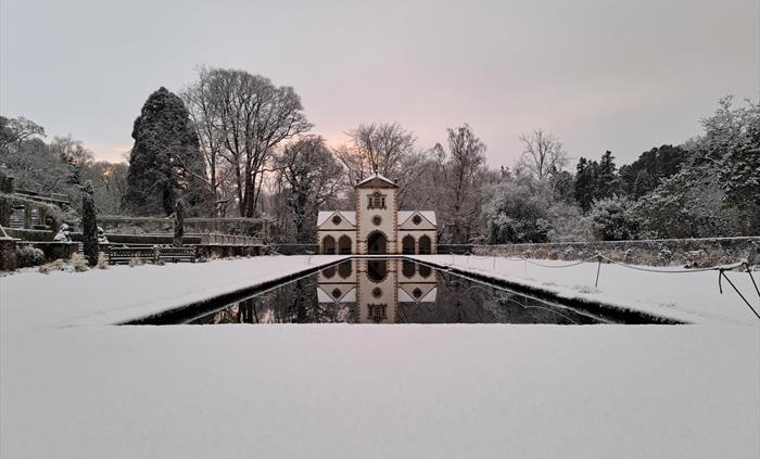 Snow covers the surrounding lawn and roof of the Pin Mill on the Canal Terrace at Bodnant Garden, Conwy, in North Wales